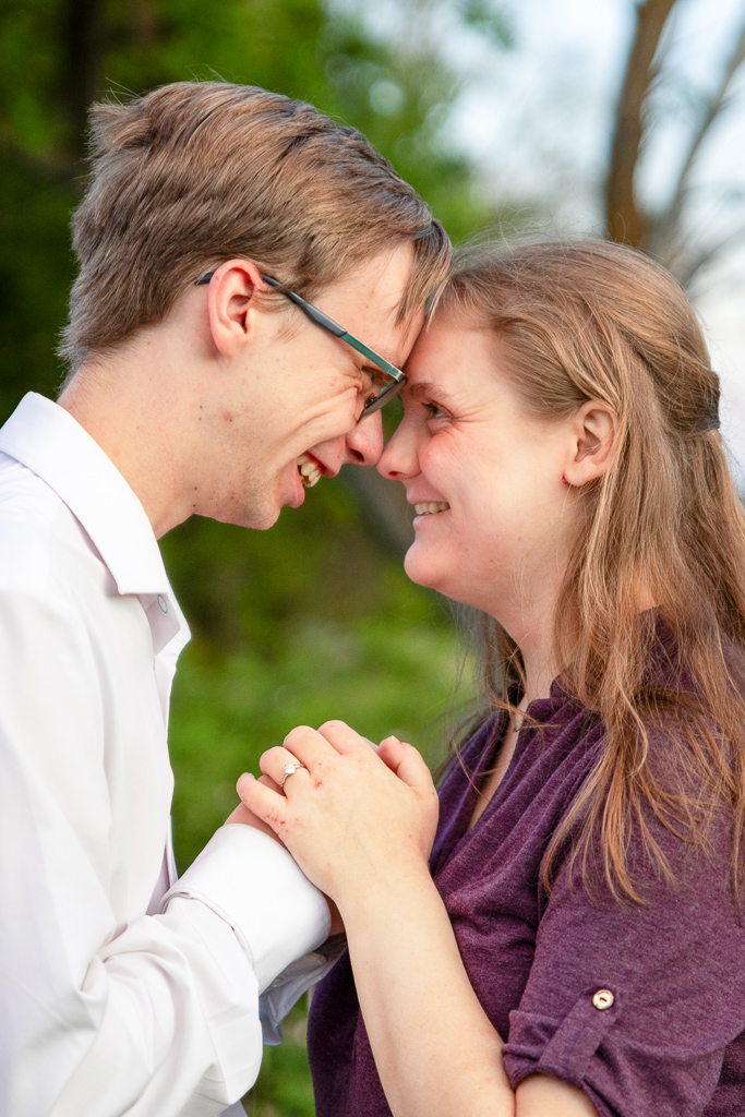 Jon and Brooke standing nose to nose, looking into each other's eyes, while holding hands.